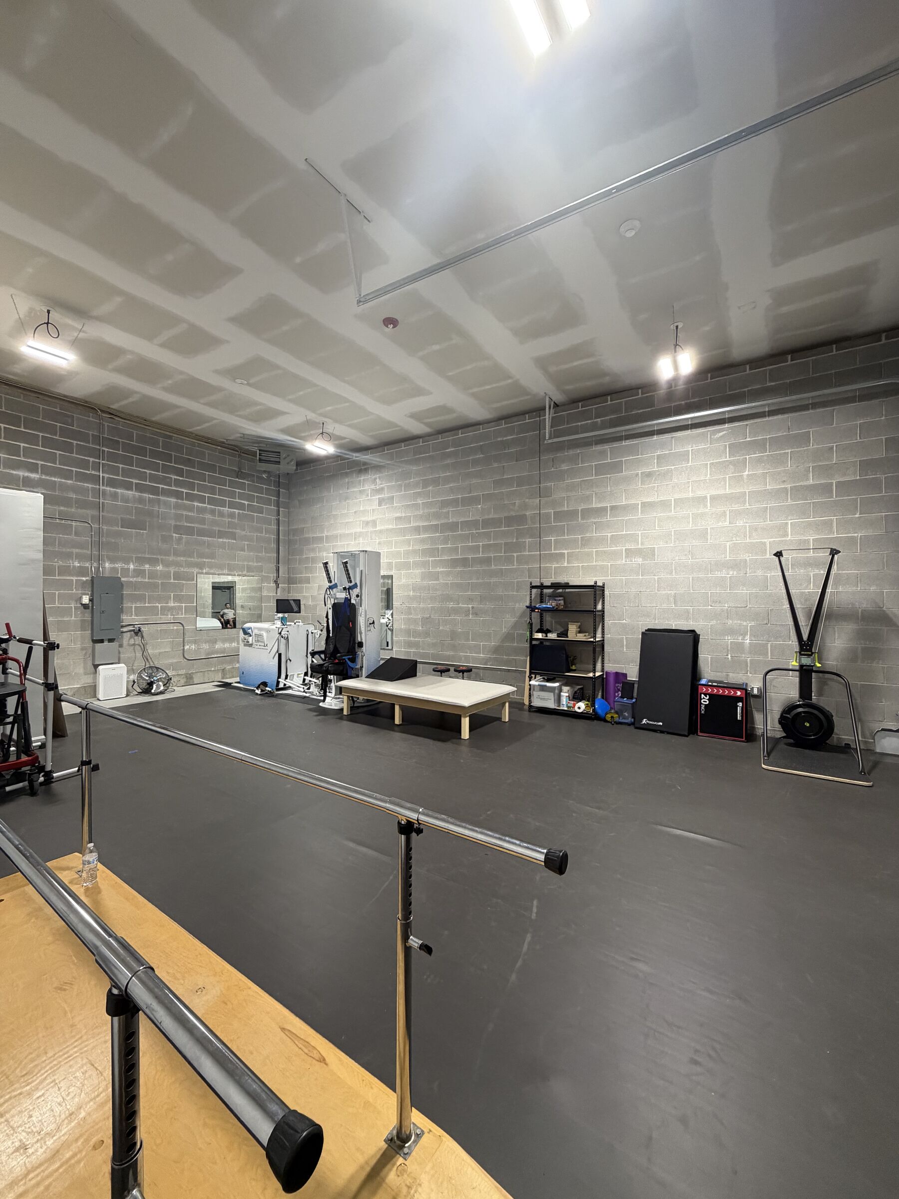 The STRIDE SCI gym space with parallel bars and adaptive training equipment